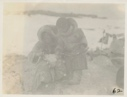 Image of Eskimos [Inuit] picking ducks